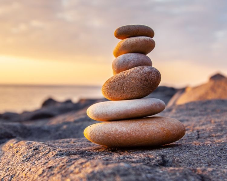 Stones pyramid on the seashore at sunset
